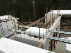 Slab Form cantilevers over load bearing walls stopping each side to form an additional lintel